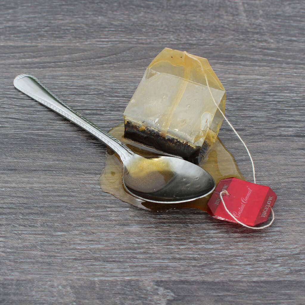 Tea Bag &amp; Spoon In Puddle