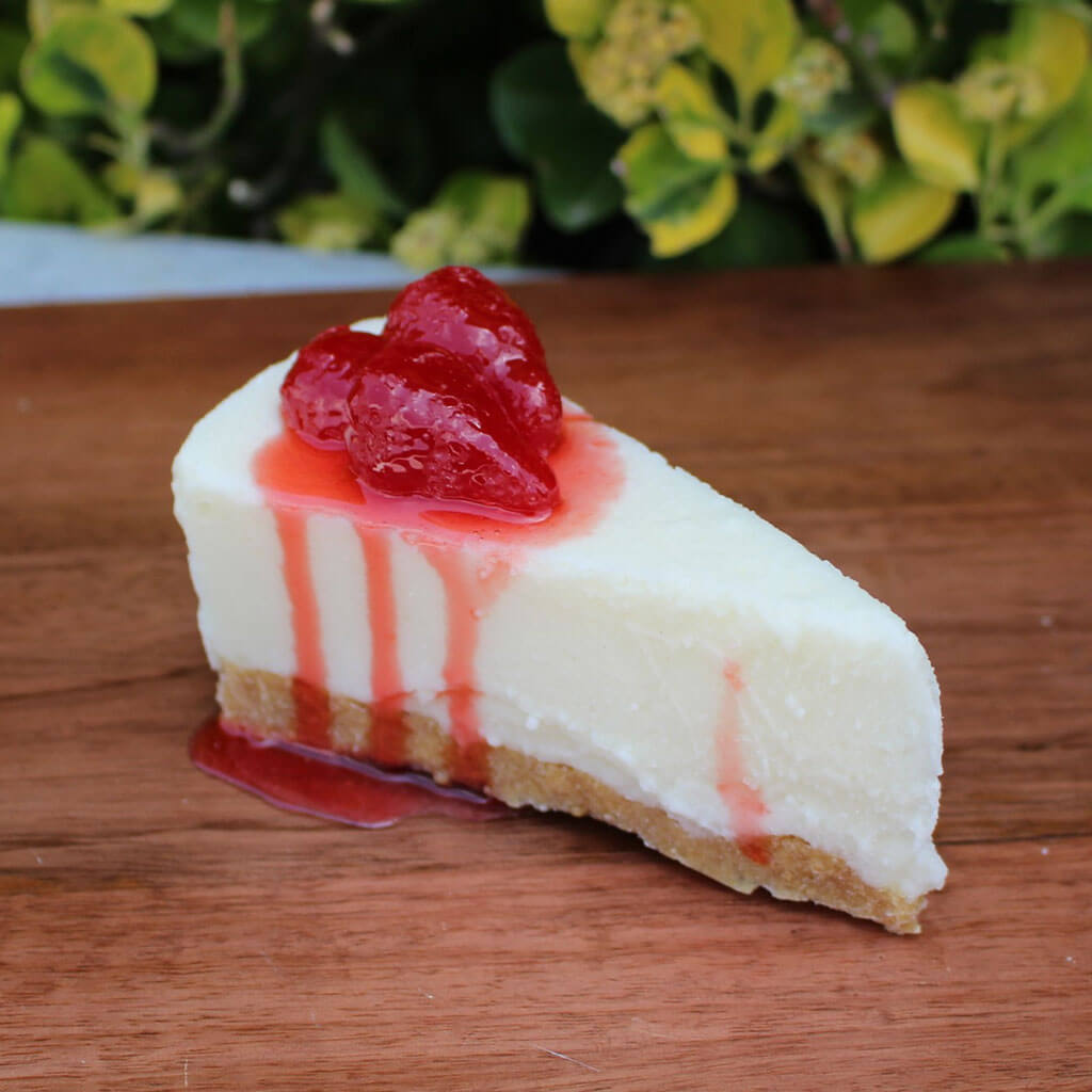 Slice Of Cheesecake Topped With Strawberries